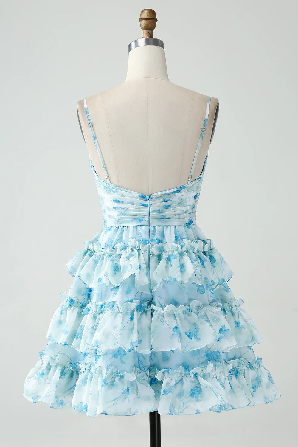 Side view of a blue floral A-line tiered pleated short homecoming dress.