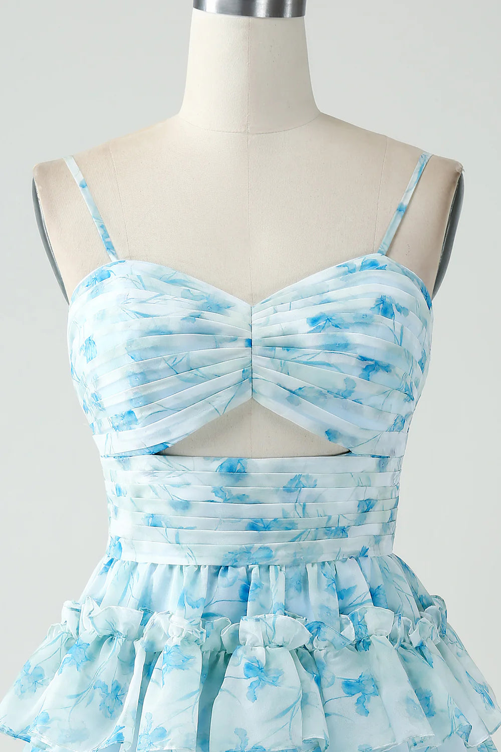 Close-up of the floral pattern and tiered pleats on the blue dress.
