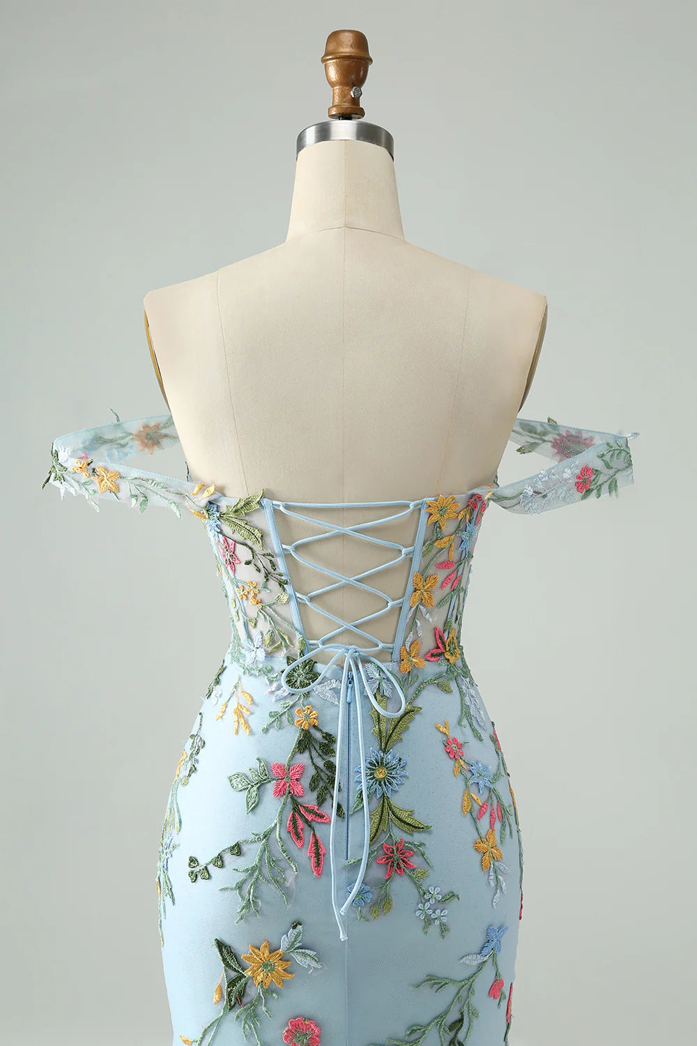 Back view of blue floral mermaid off-shoulder dress with corset detail.