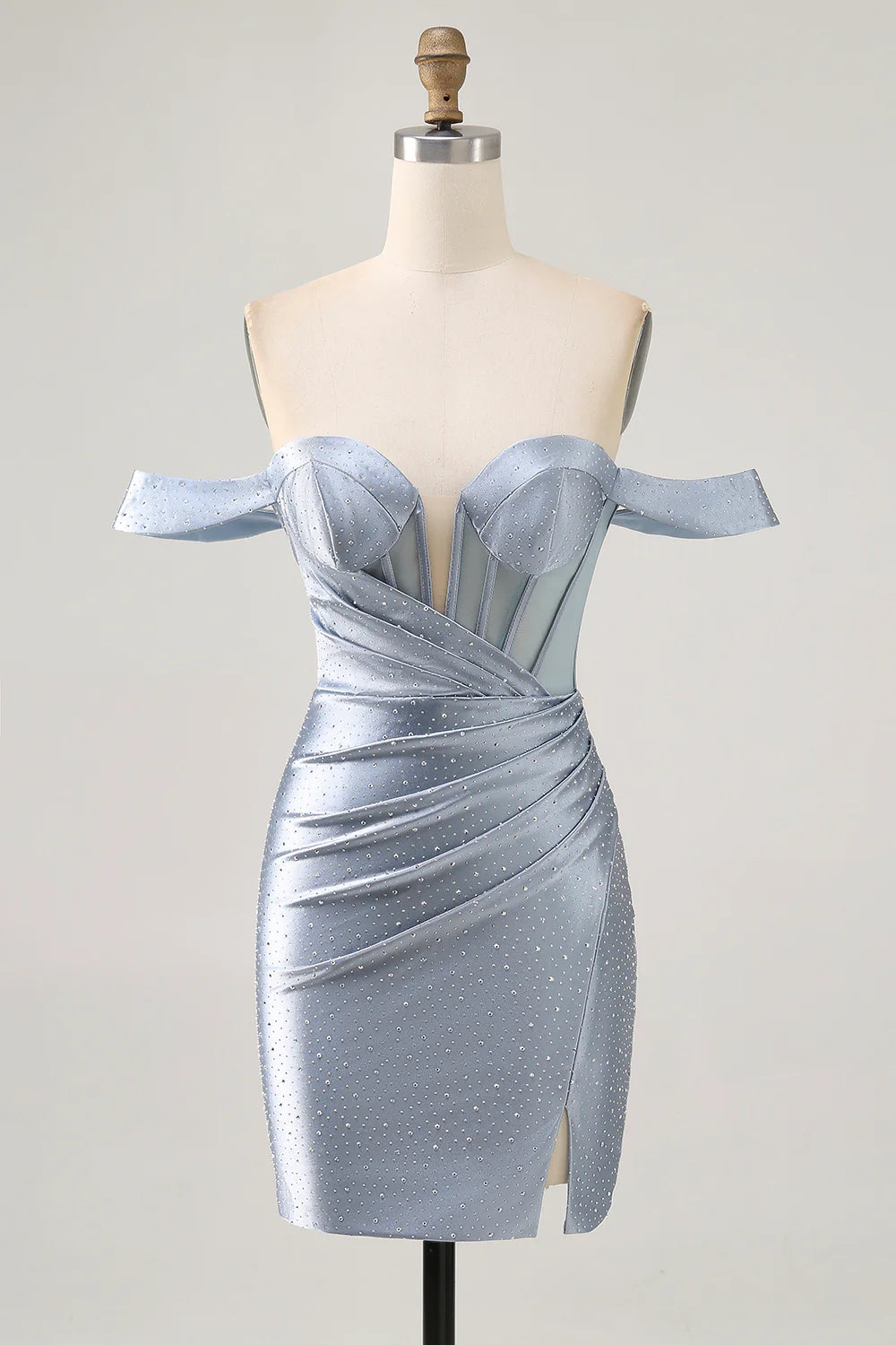 Model wearing a dusty blue bodycon off-shoulder homecoming dress with a high slit.