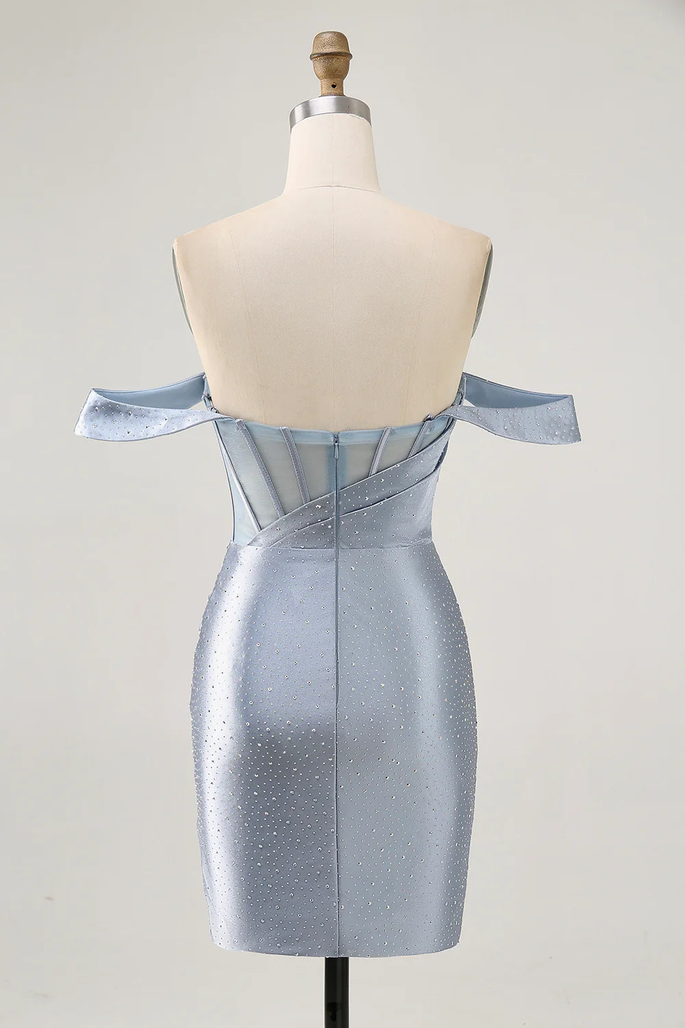 Side view of a model in a dusty blue beaded corset dress.