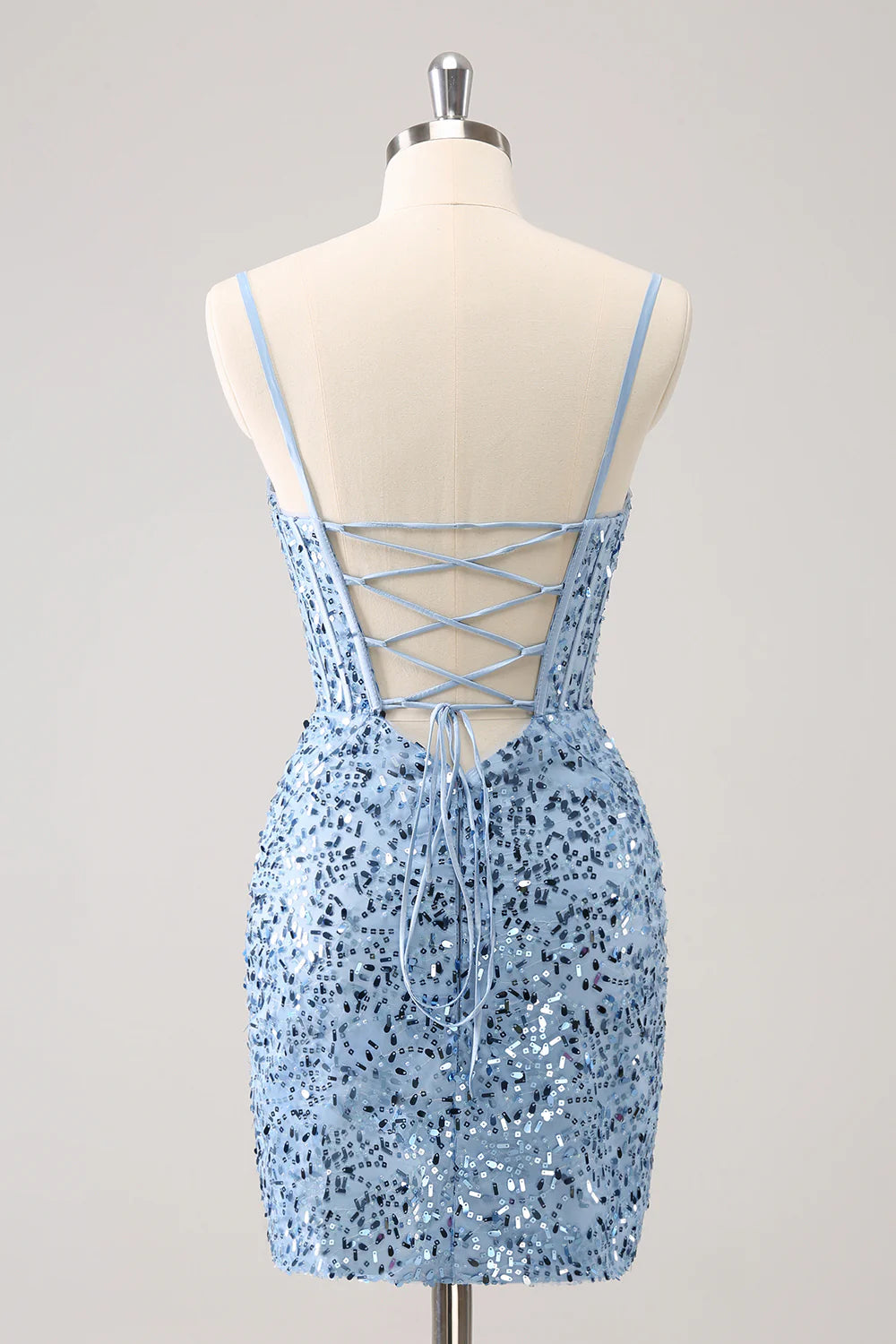 Side view of the blue sequined bodycon dress, showing the short length and corset detail.