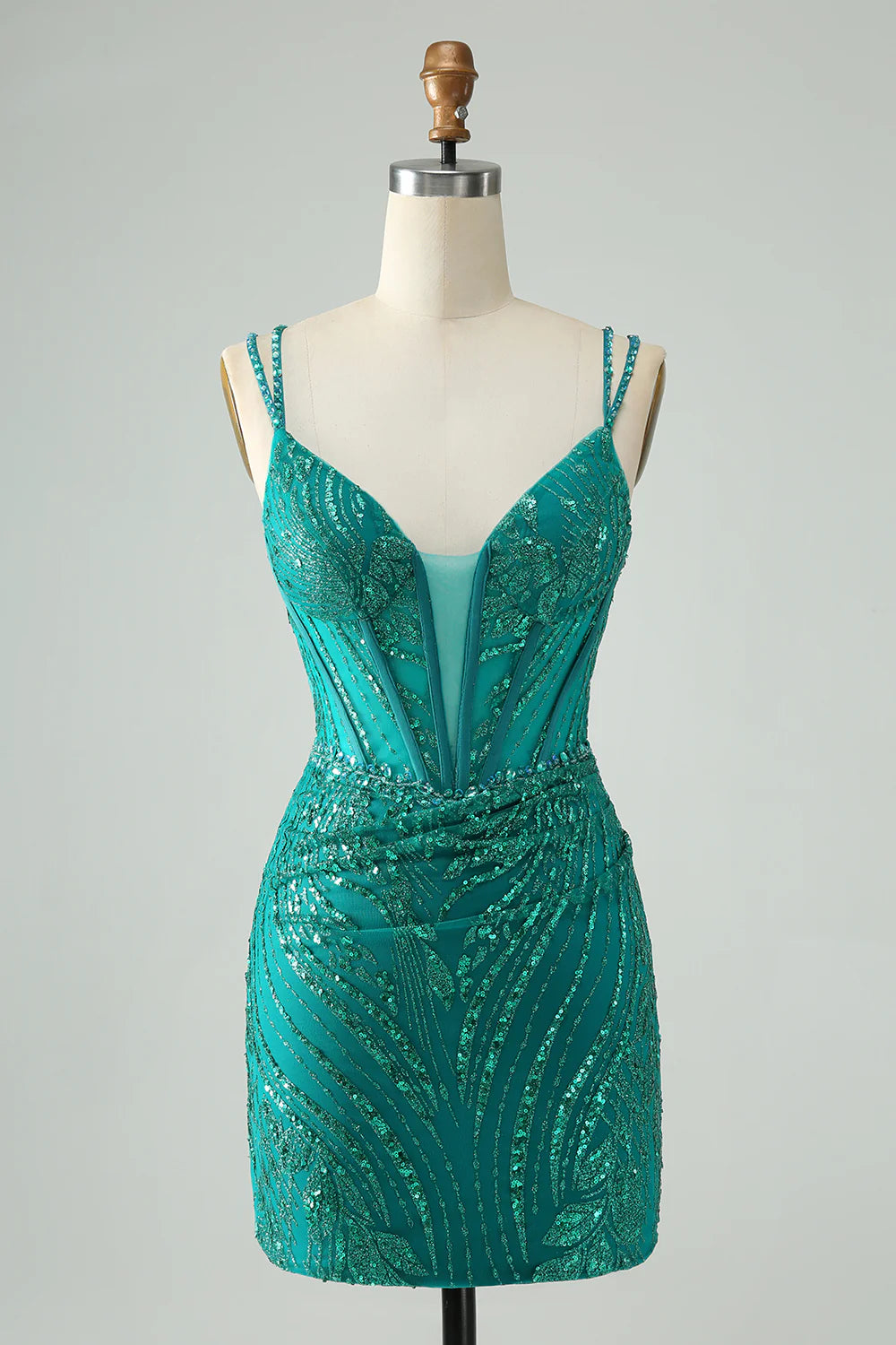 Model wearing a dark green sequin bodycon short homecoming dress with spaghetti straps.