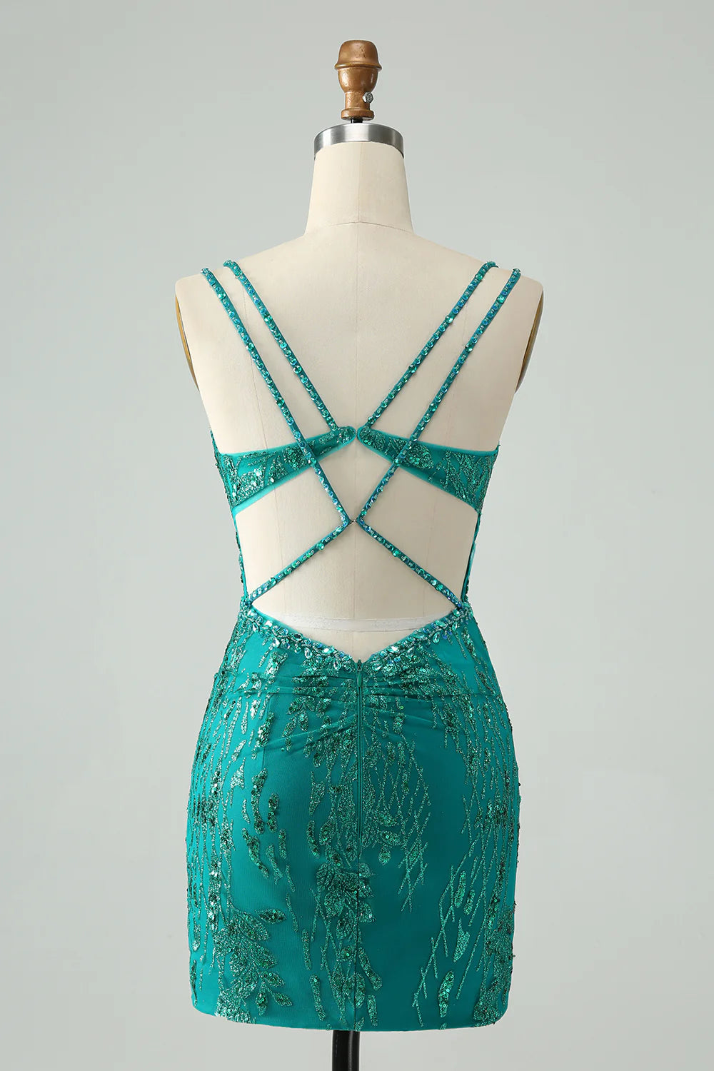 Close-up of the dark green sequin fabric and corset detail on the bodycon dress.