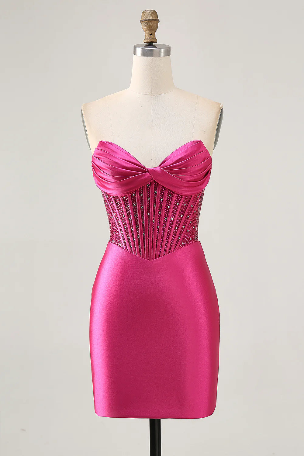Fuchsia strapless bodycon dress with beaded corset detail.