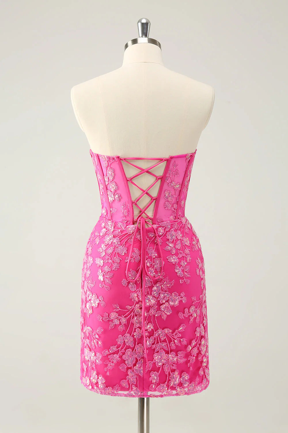 Back view of a sequined fuchsia strapless bodycon dress.