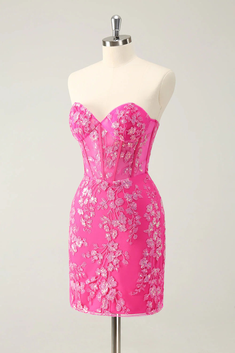 Side view of a short fuchsia sequin corset dress.