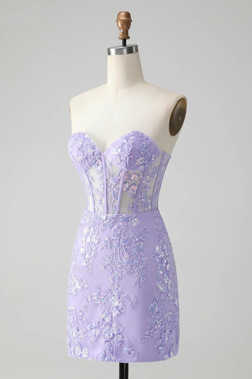Side view of a model in a short lilac sequin dress with a sweetheart neckline.