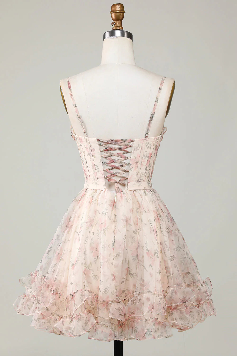 Back view of champagne floral homecoming dress showing lace-up detail.