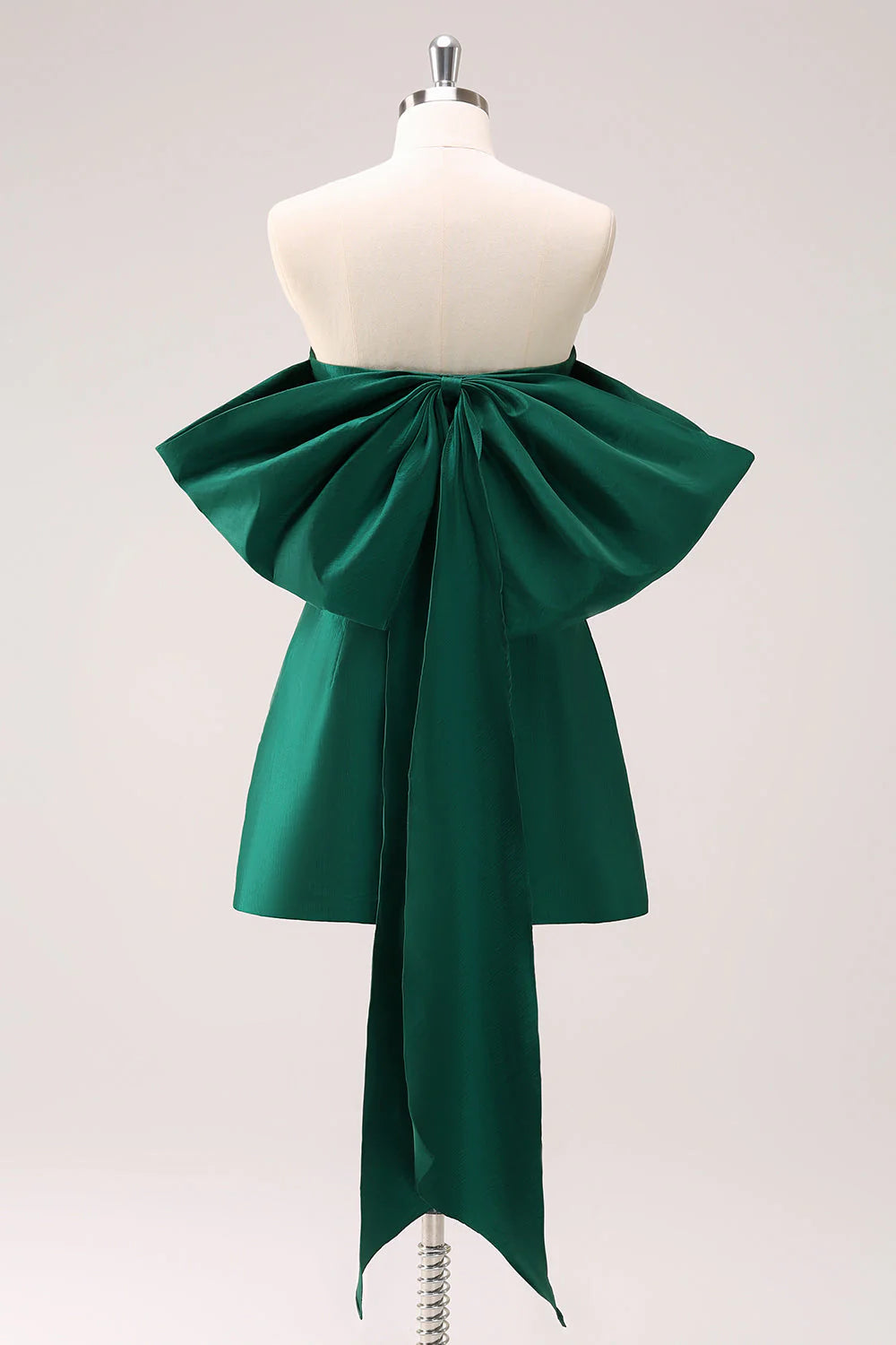 Model posing in a dark green strapless A-line homecoming dress.