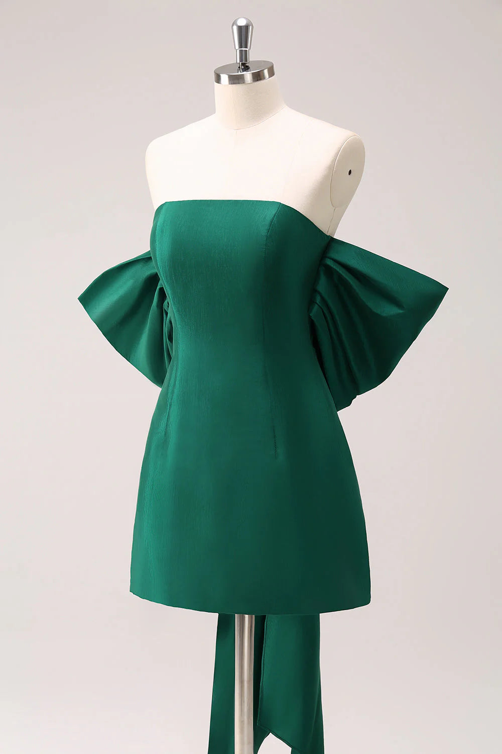 Back view of the dark green short homecoming dress with bow detail.