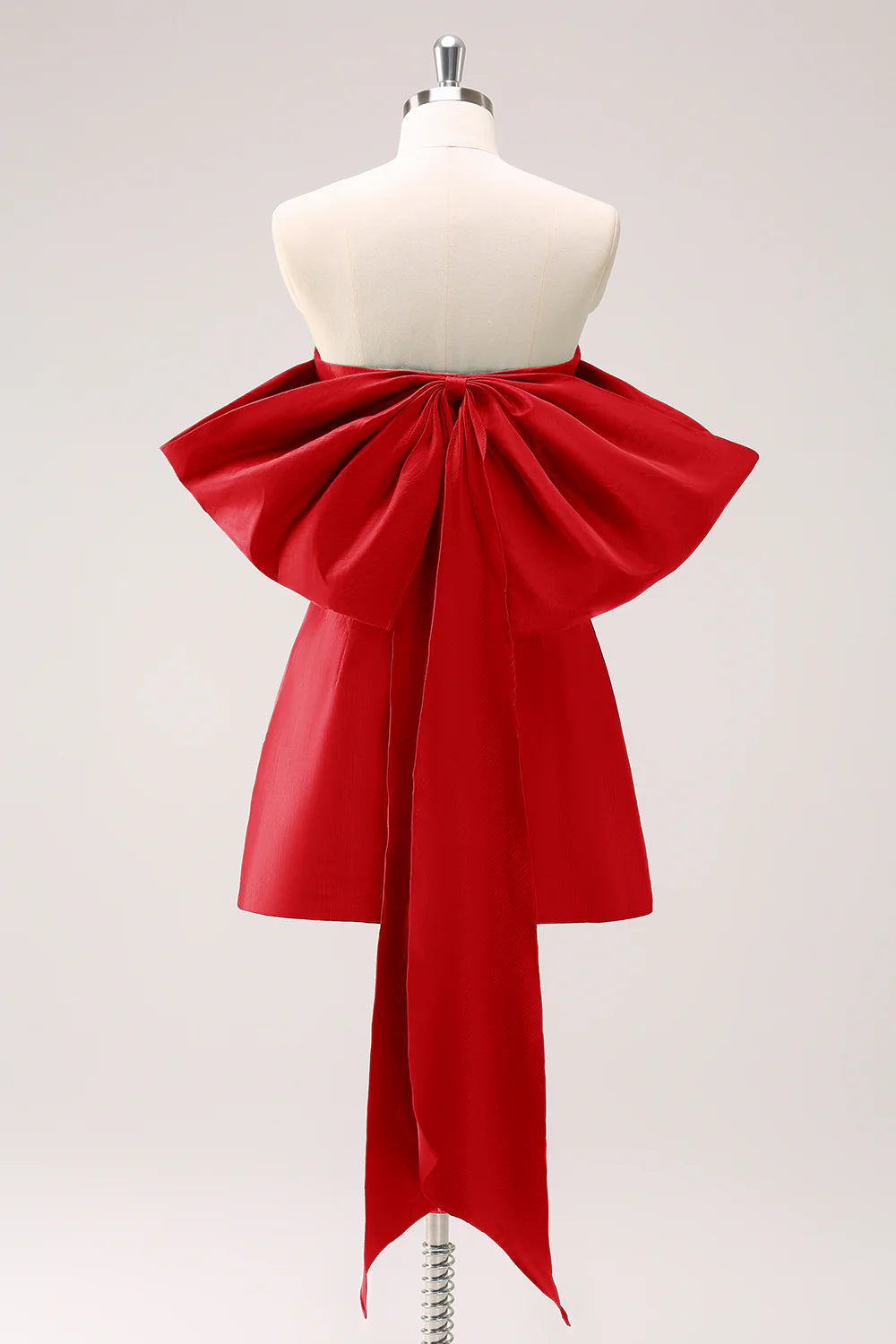 Model in a red strapless A-line homecoming dress.