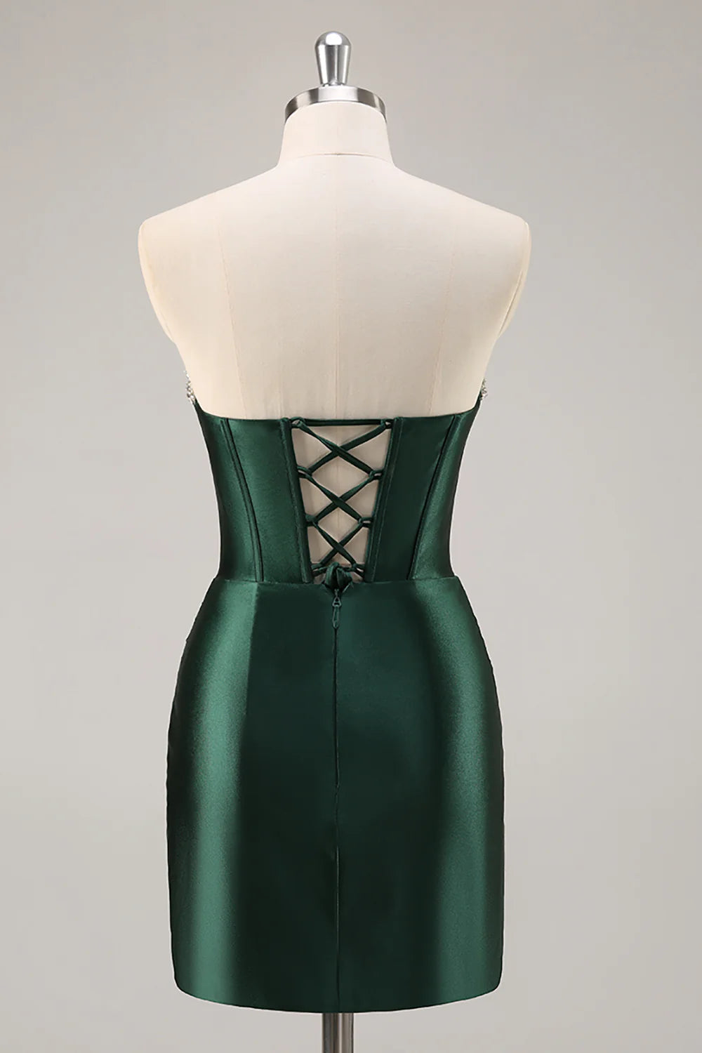 Side view of the dark green strapless bodycon satin dress, showcasing the ruched detailing and silhouette.