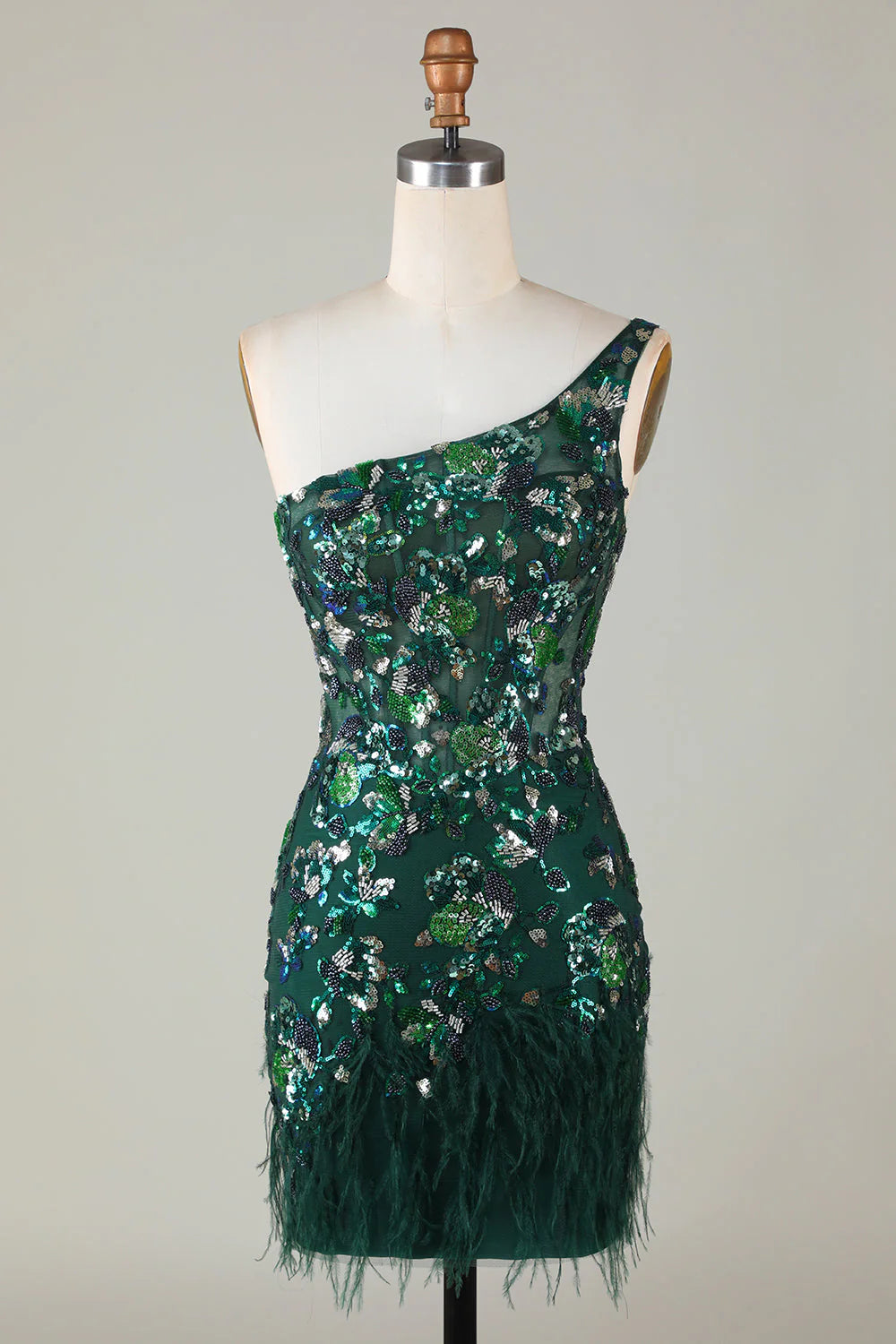 Model wearing a dark green sequined one-shoulder short homecoming dress with feather trim.