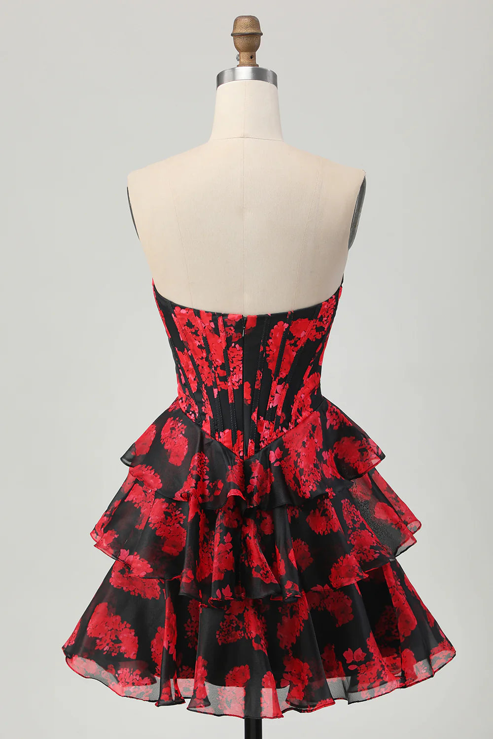 Side view of the black and red floral A-line strapless homecoming dress.