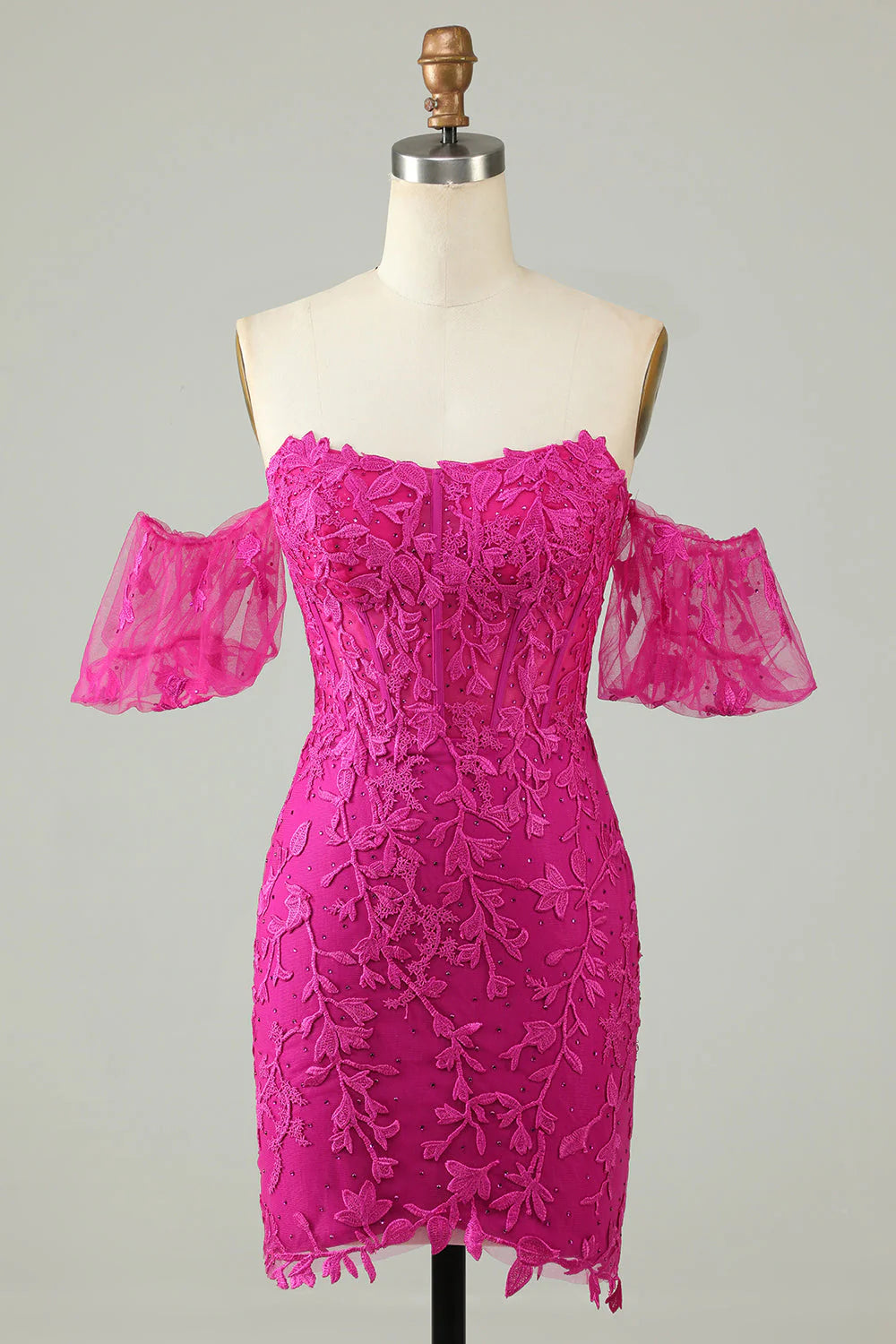 Fuchsia sheath homecoming dress with off-the-shoulder neckline and appliques.