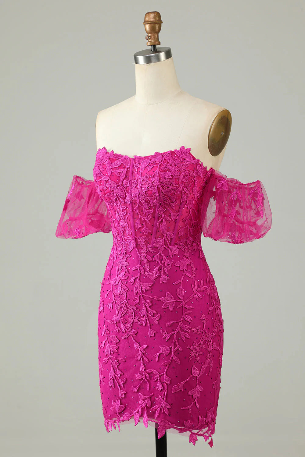 Side view of fuchsia off-the-shoulder dress with intricate appliques.