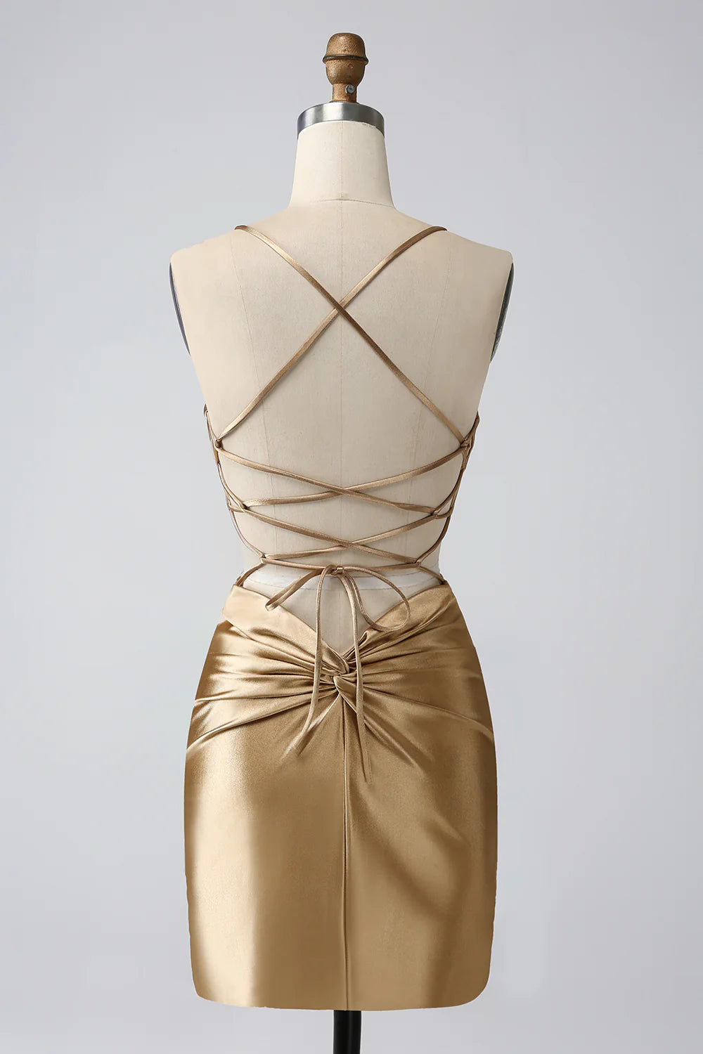 Back view of the golden bodycon dress showing lace-up detail.