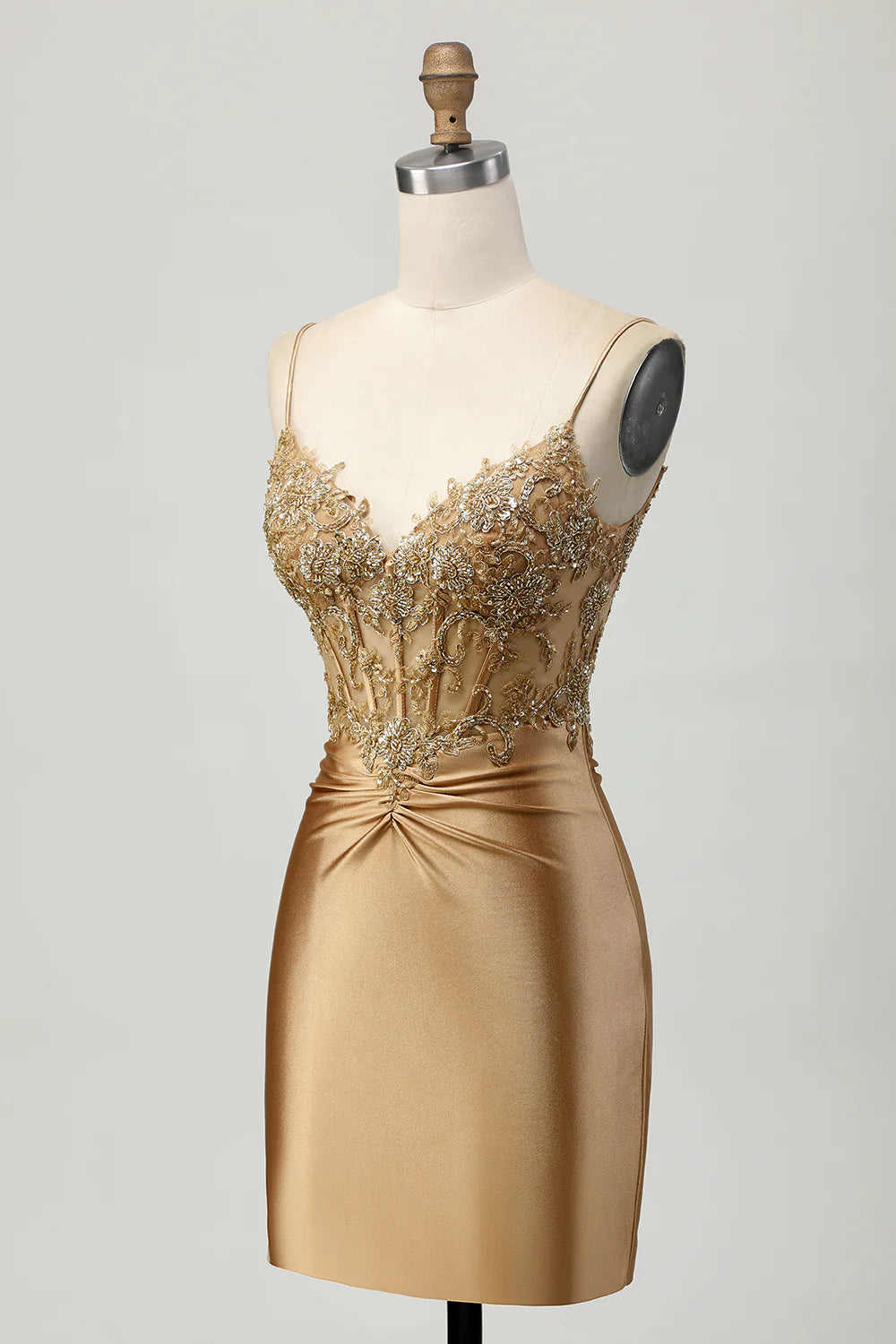 Side view of golden satin short homecoming dress with intricate appliques.