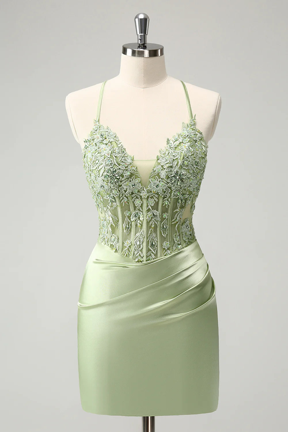 Elegant green sheath homecoming dress with criss-cross back and appliques.