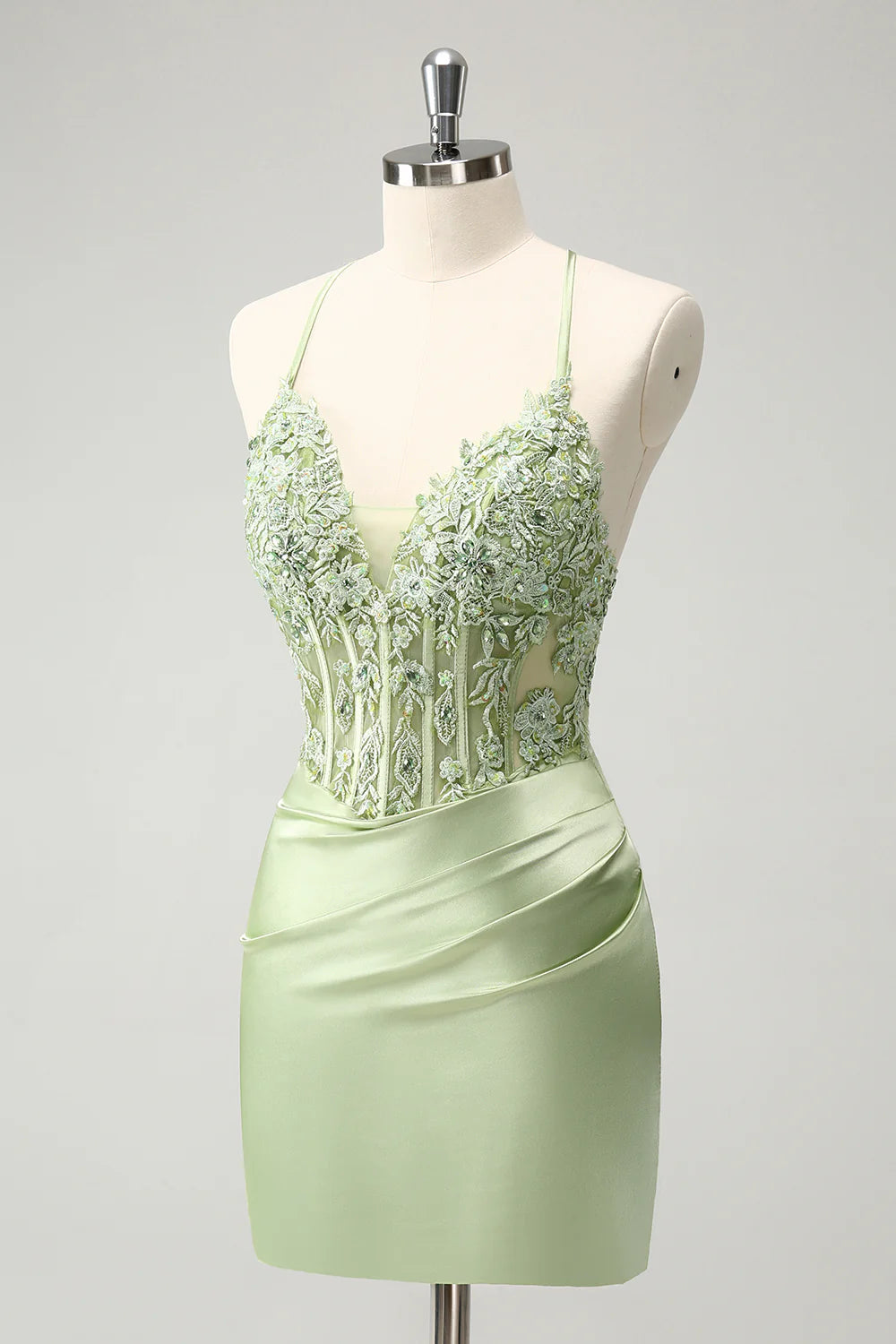 Side view of green short dress with appliques and strapless design.
