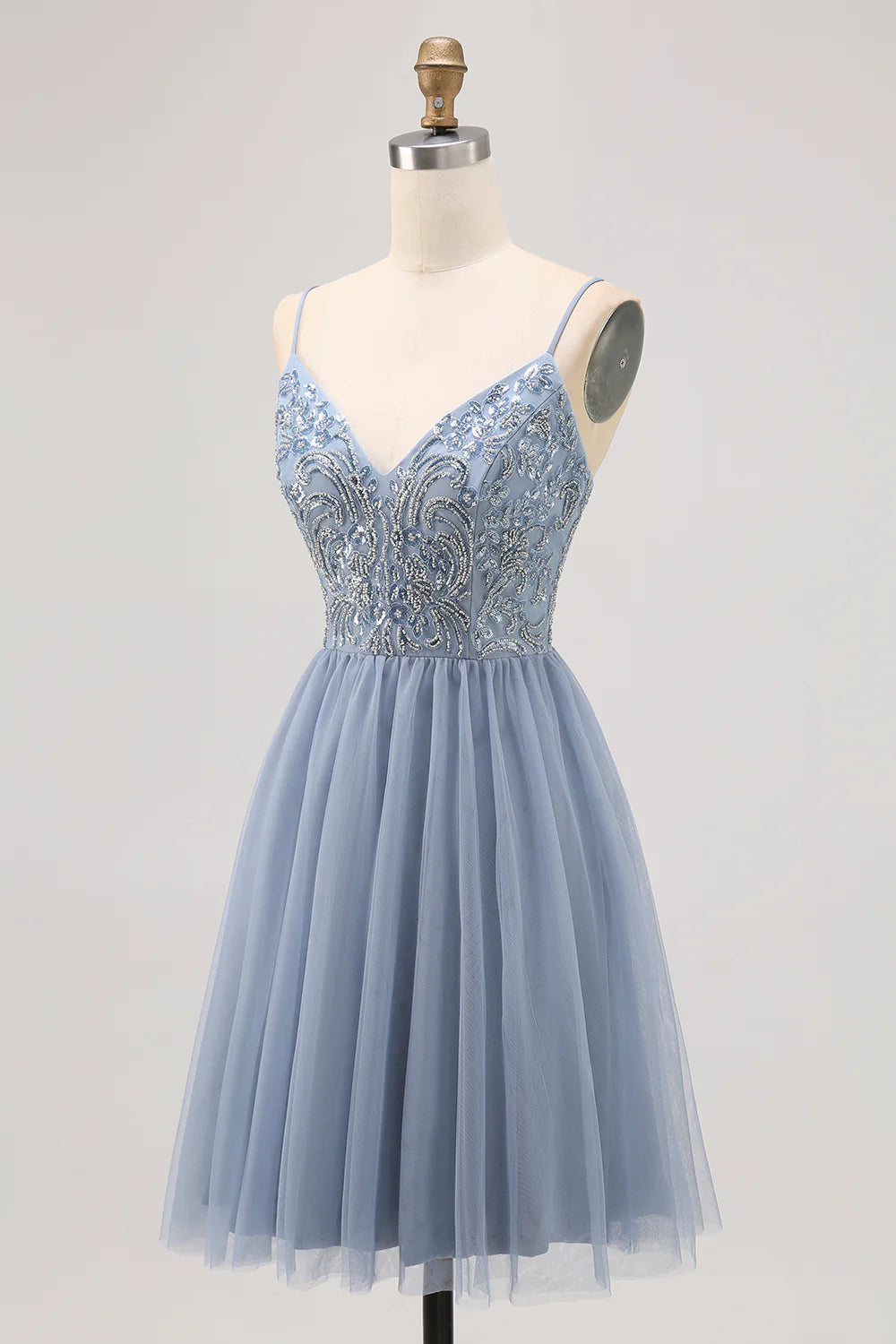 Close-up of beaded appliques on grey blue homecoming dress.