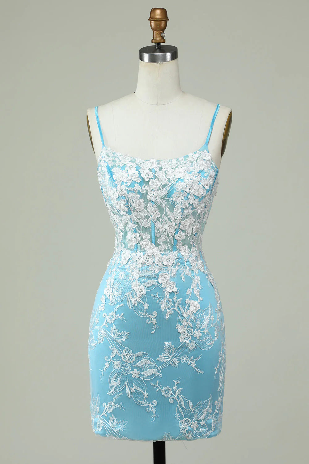 Model wearing an elegant light blue sheath homecoming dress with spaghetti straps and appliques.