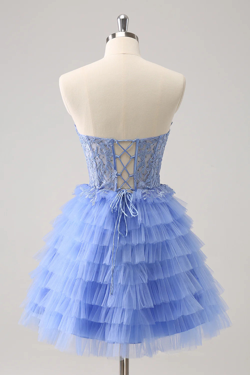 Close-up of the beaded corset bodice and lace-up back on a lilac formal gown.
