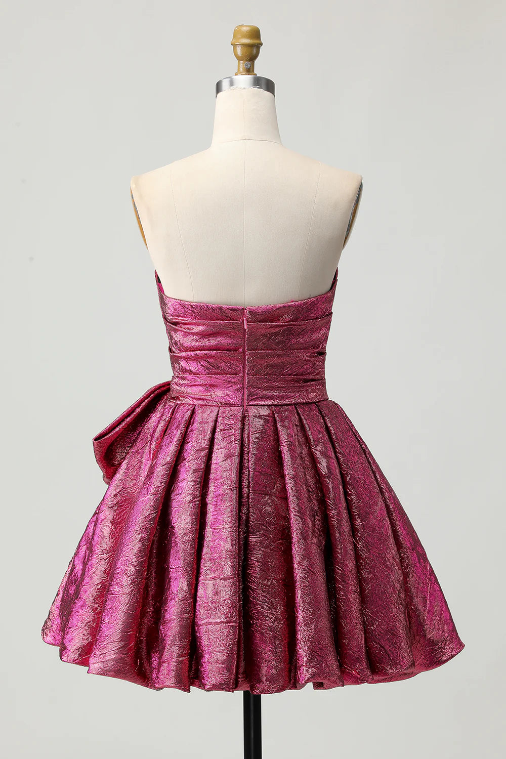 Side view of the metallic dark purple ruched strapless homecoming dress, highlighting the bow detail.