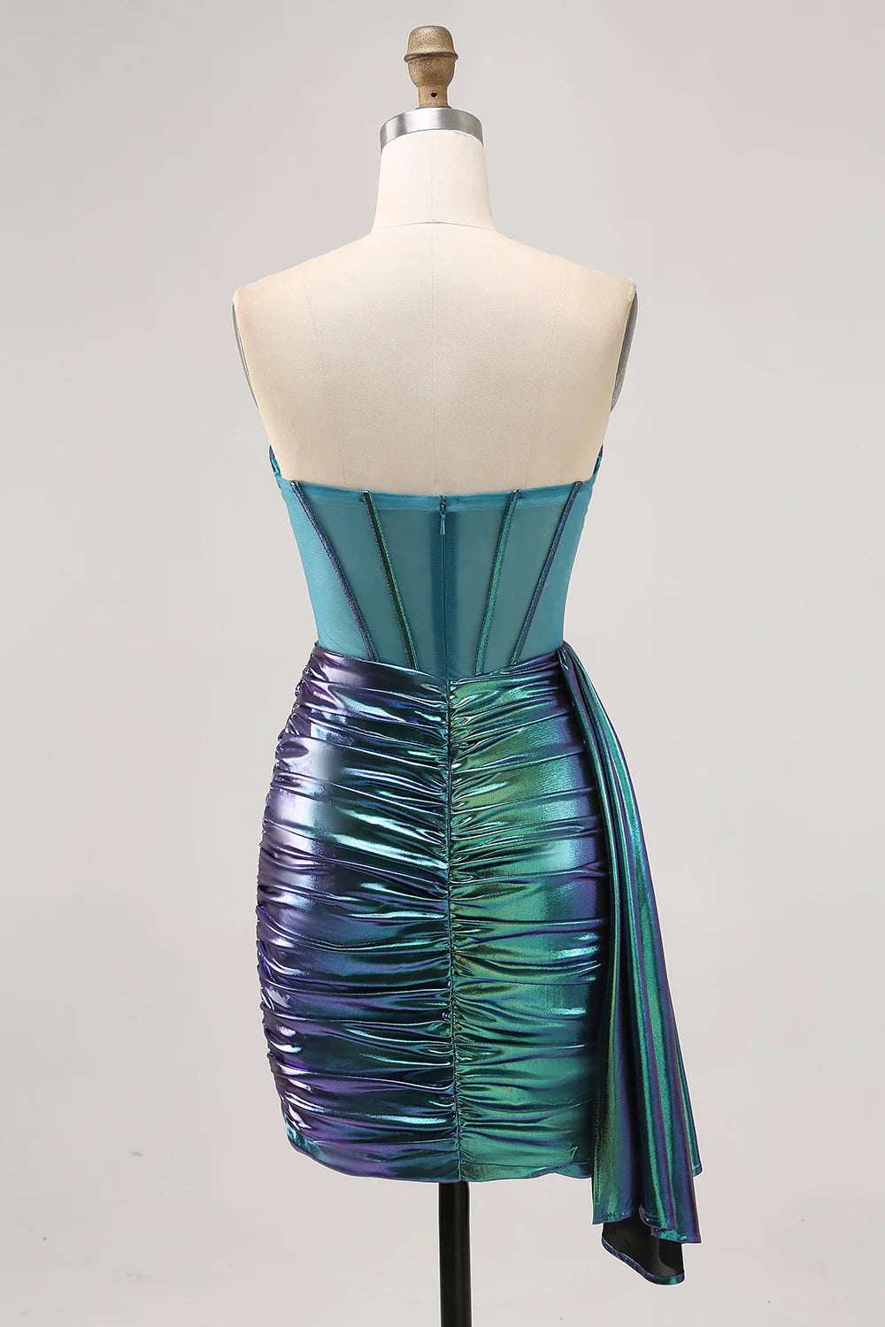 Back view of the metallic green strapless corset ruched short homecoming dress, highlighting the side cape.