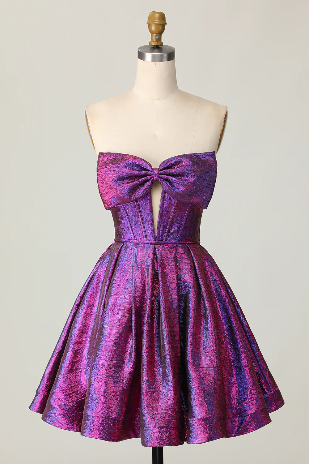Dark purple metallic strapless A-line homecoming dress with a large bow on the back.