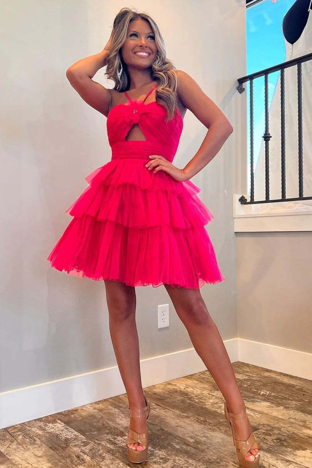 Back view of a model in a red tiered tulle homecoming dress.