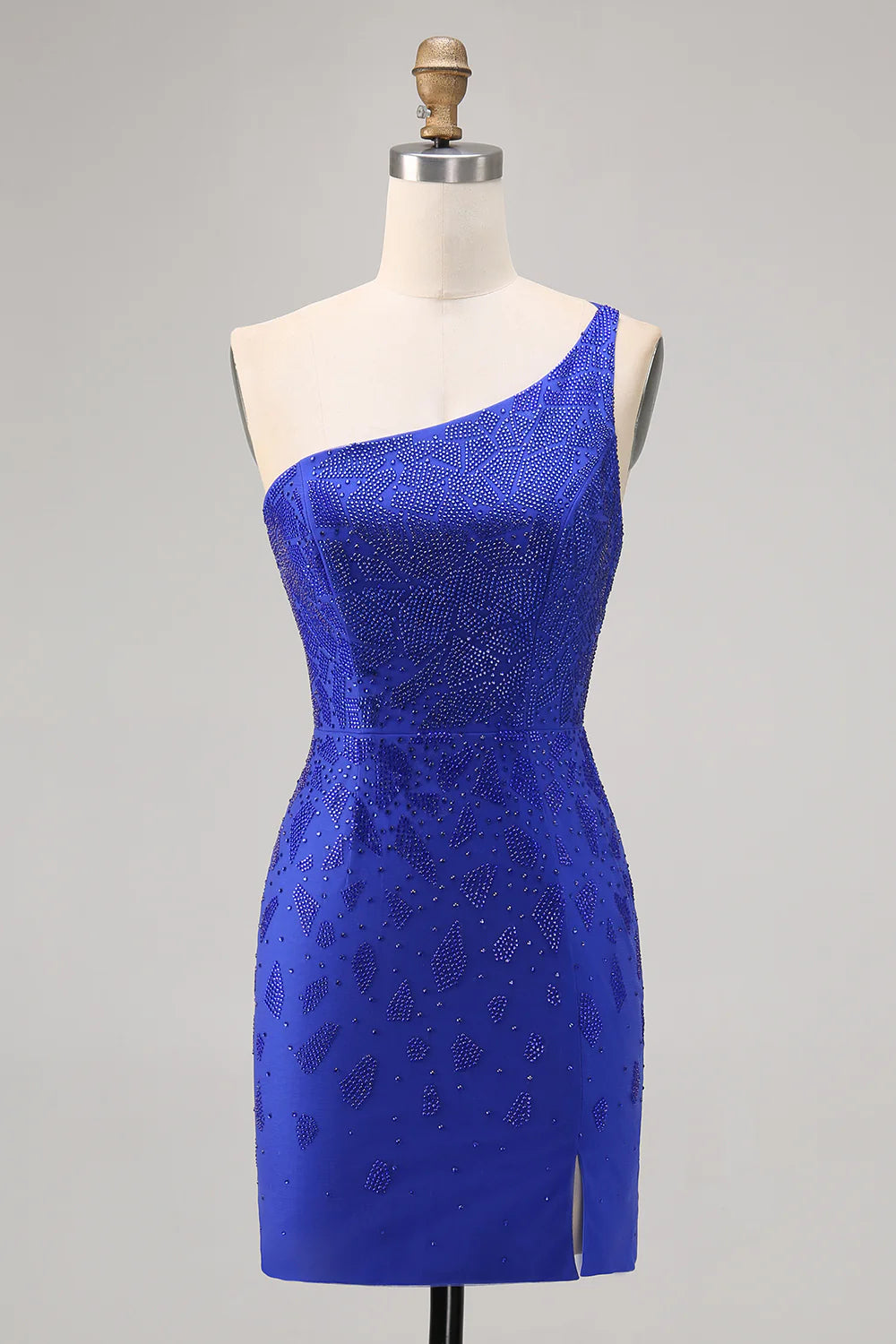 Model wearing a royal blue bodycon one-shoulder beaded homecoming dress with a high slit, front view.