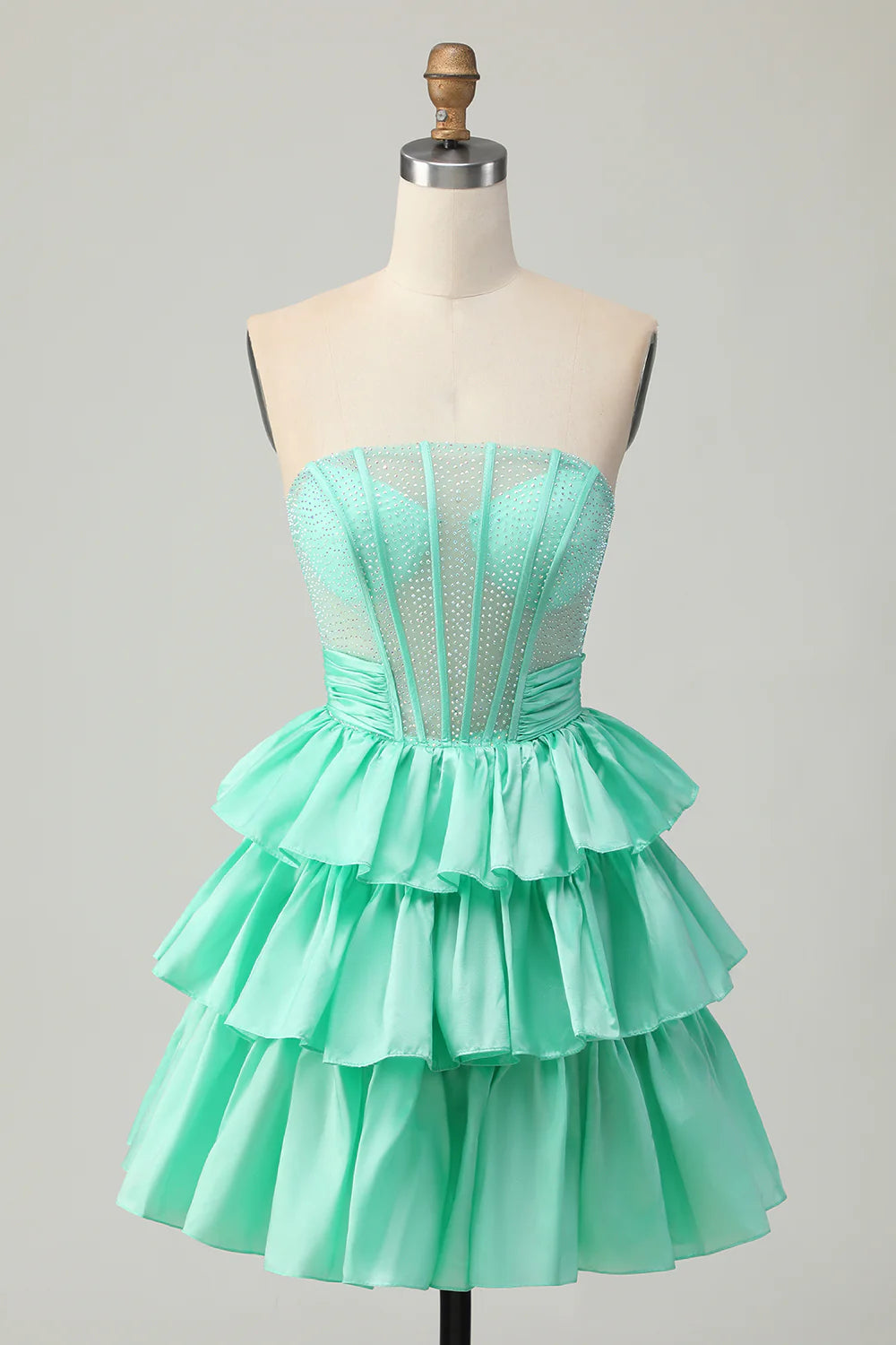 Strapless A-line tiered homecoming dress with corset bodice and bow.
