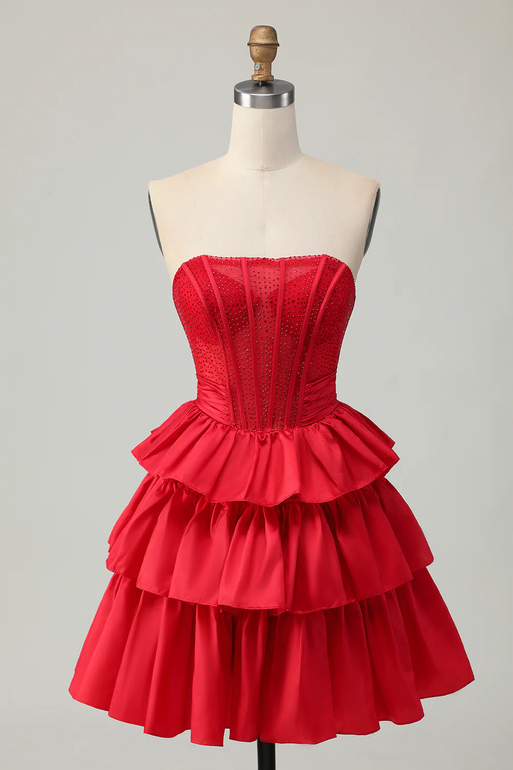 Side view of tiered skirt and bow detail on A-line homecoming dress.