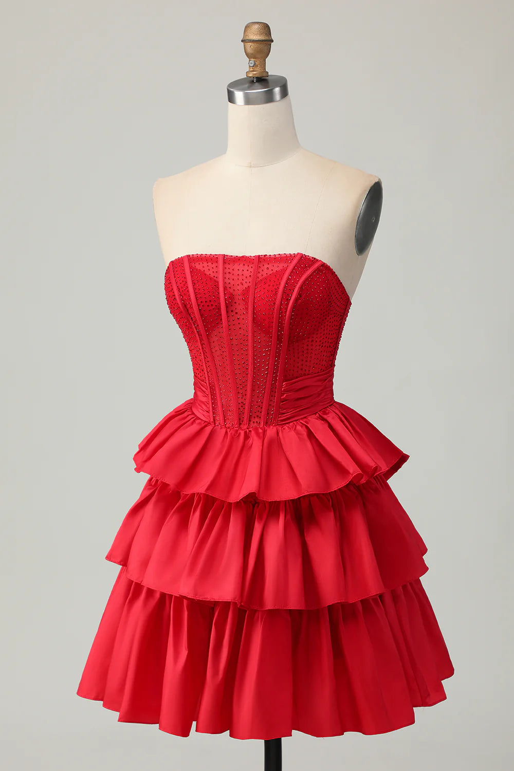 Full length view of strapless A-line tiered homecoming dress.