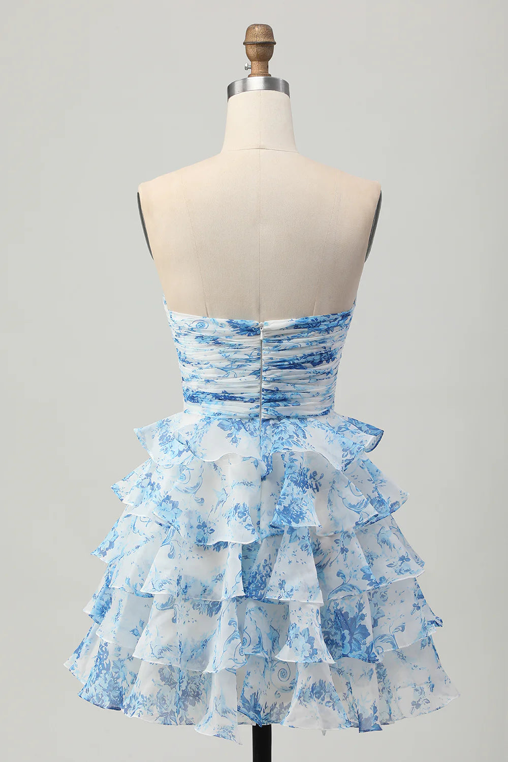 Back view of the white and blue floral strapless A-line tiered short homecoming dress.