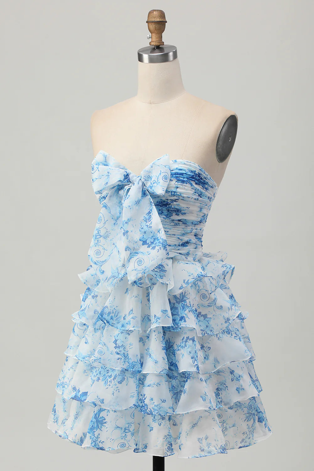Side view of the white and blue floral strapless A-line tiered short homecoming dress.