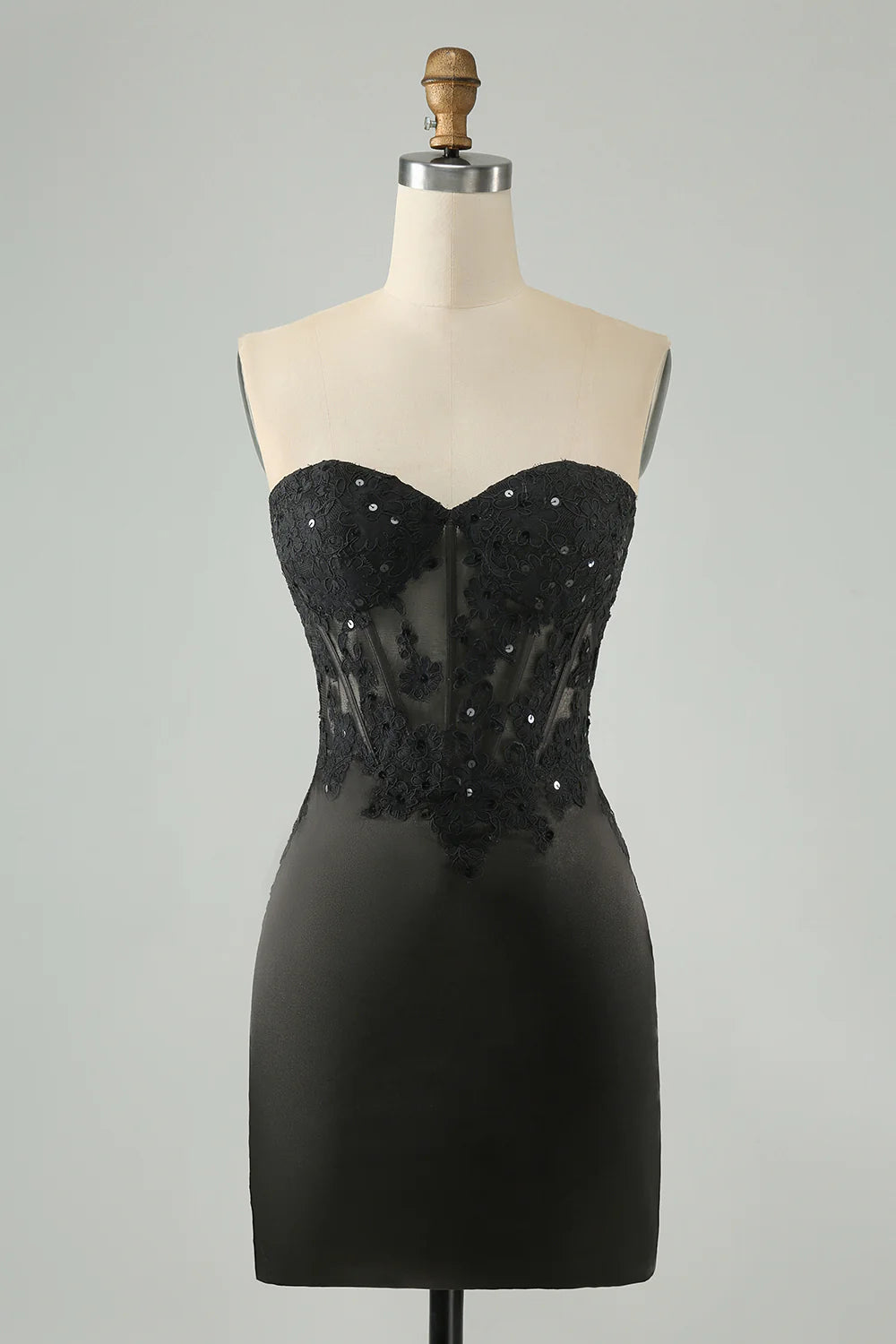 Black bodycon homecoming dress with sweetheart corset neckline and appliques.