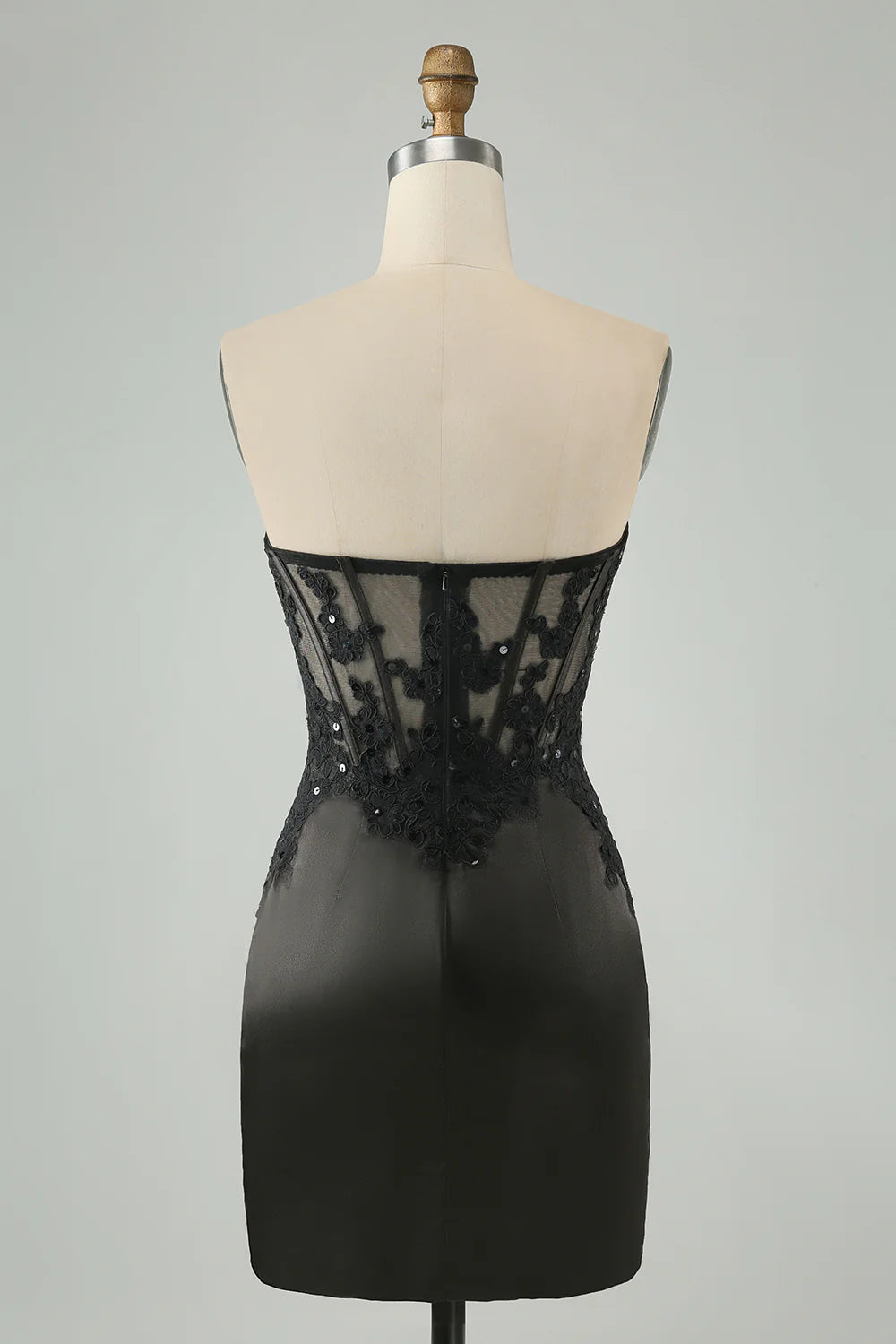 Side view of a black short bodycon dress featuring a sweetheart neckline.