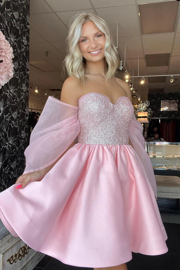 Elegant light pink sequin homecoming gown with a strapless sweetheart neckline.