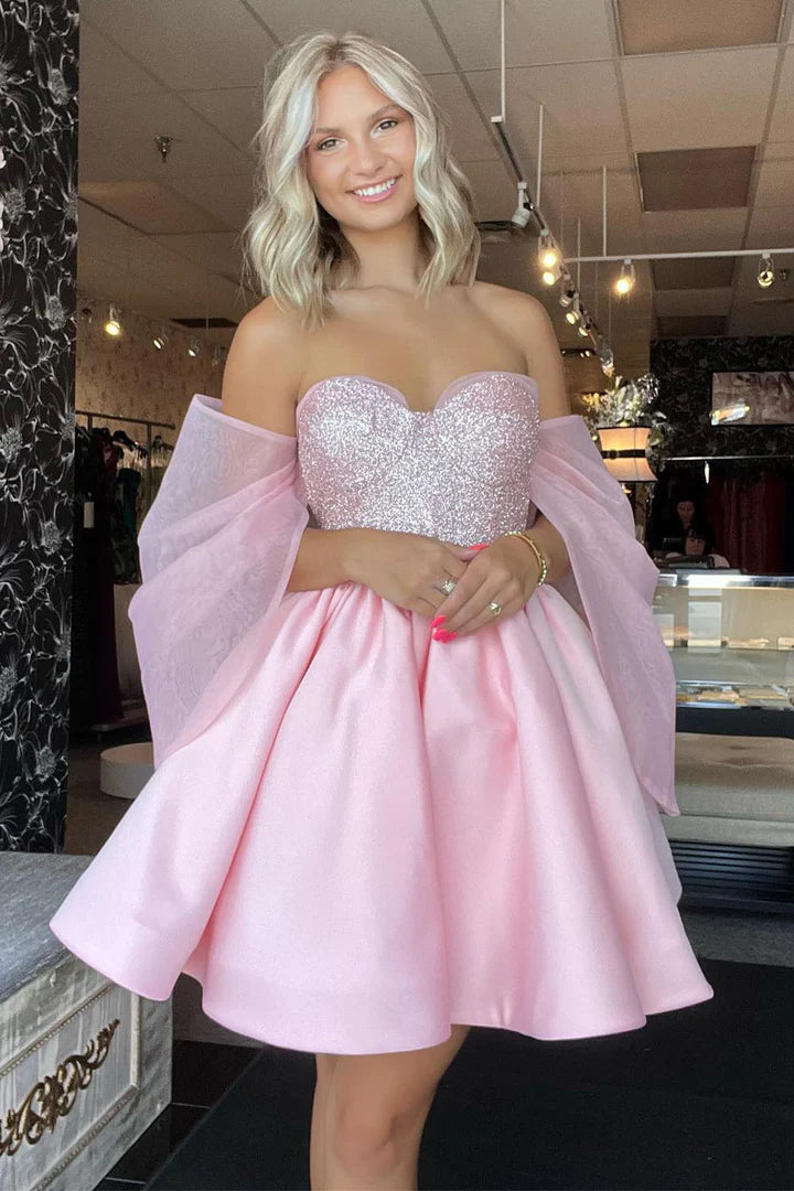 Close-up of the shimmering sequin fabric on the light pink formal dress.