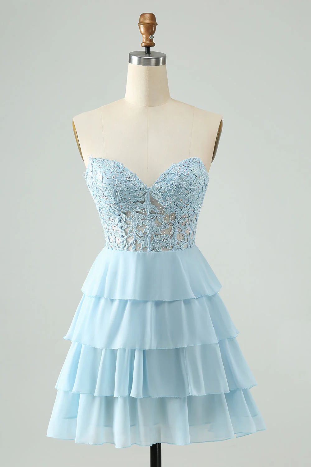 Light blue sweetheart tiered short homecoming dress with appliques, front view.