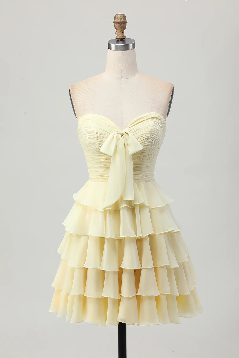 Light yellow tiered strapless A-line short homecoming dress.