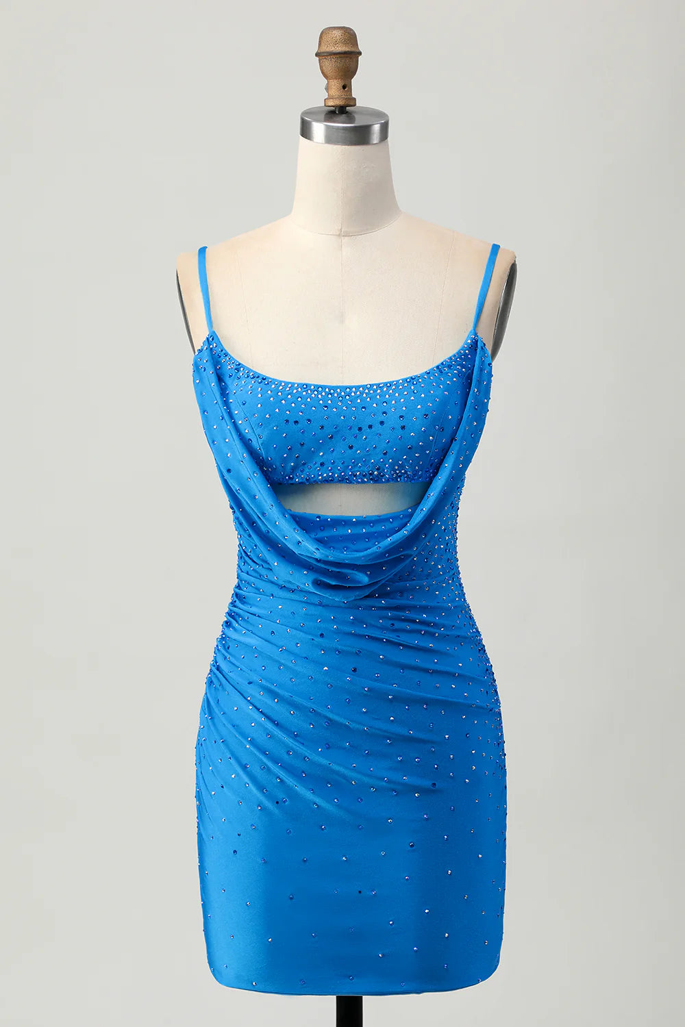 Model wearing an elegant tight cut out short blue homecoming dress with intricate beading.