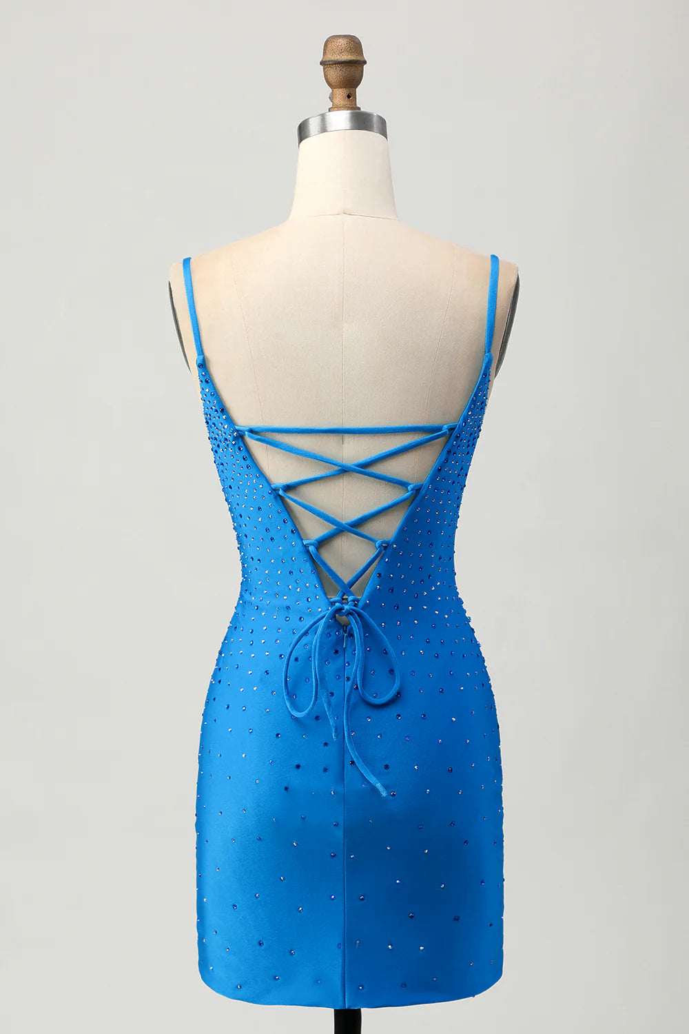 Back view of a tight cut out short blue homecoming dress, showcasing the beaded details.