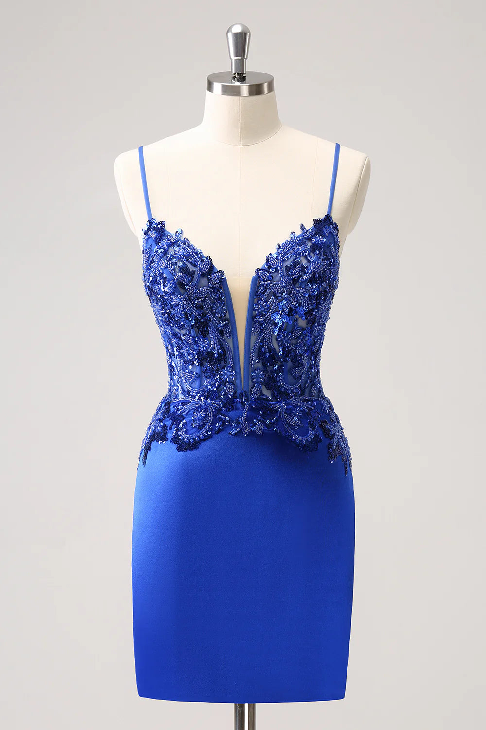 Model wearing a royal blue short ruched homecoming dress.