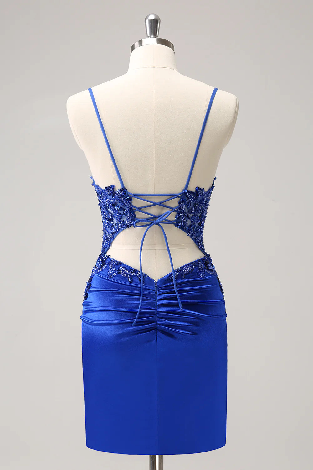 Back view of royal blue short dress showing lace-up detail.