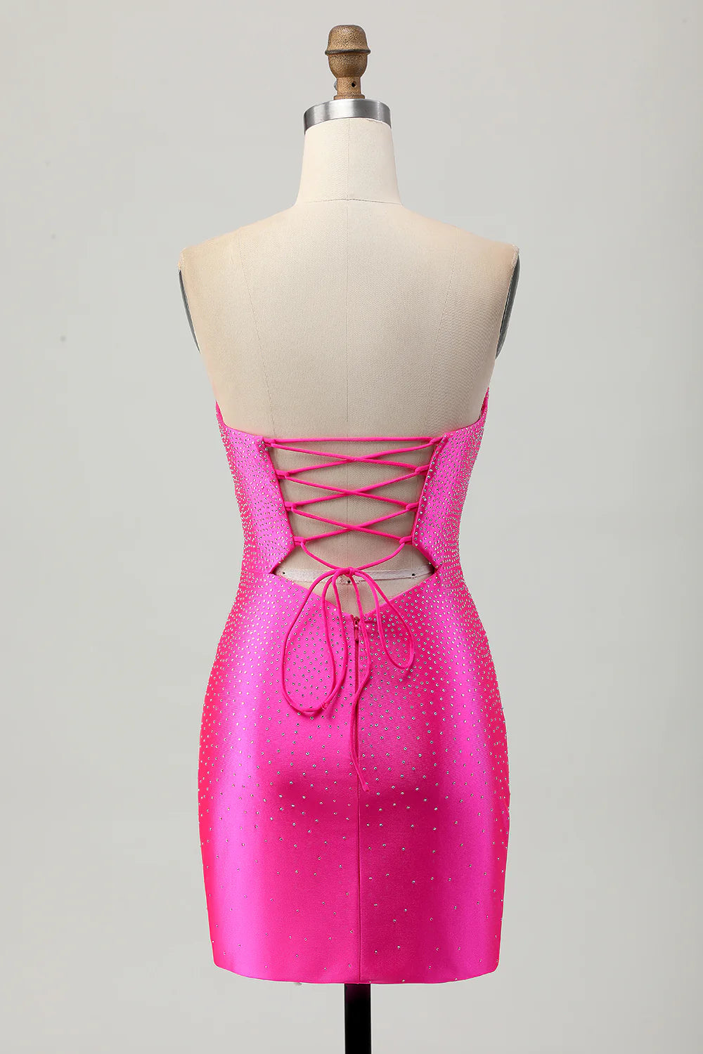 Back view of a fuchsia strapless tight satin dress with intricate beading.
