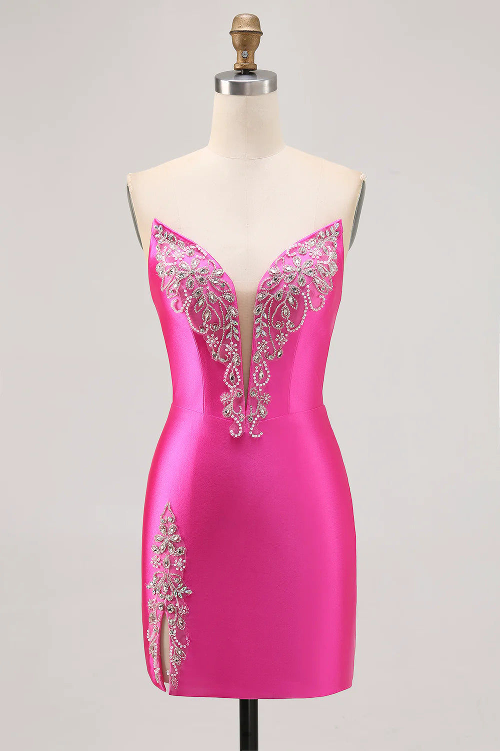 Model wearing a fuchsia strapless short satin homecoming dress with beaded details.